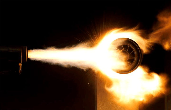 Detonationsspritzen: glühender Beschichtungsstrahl trifft ein rotierendes Bauteil